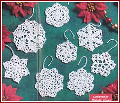 White crocheted snowflakes decorated with pearl beads